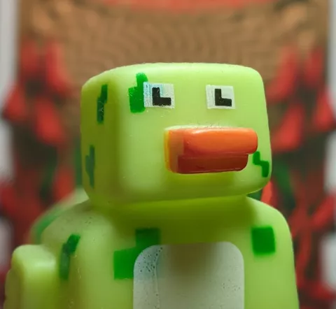 An image of a rubber duck, in minecraft style, in front of a blurred background